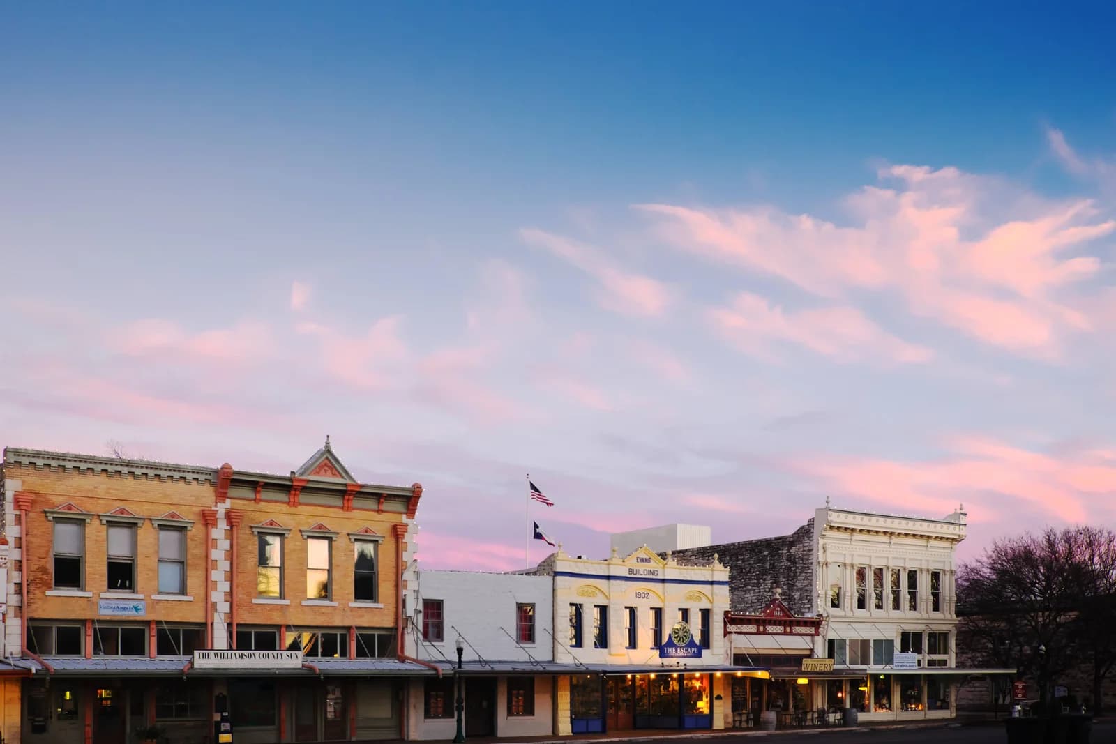 Historic storefronts and Texas flags around the town square in Georgetown, Texas